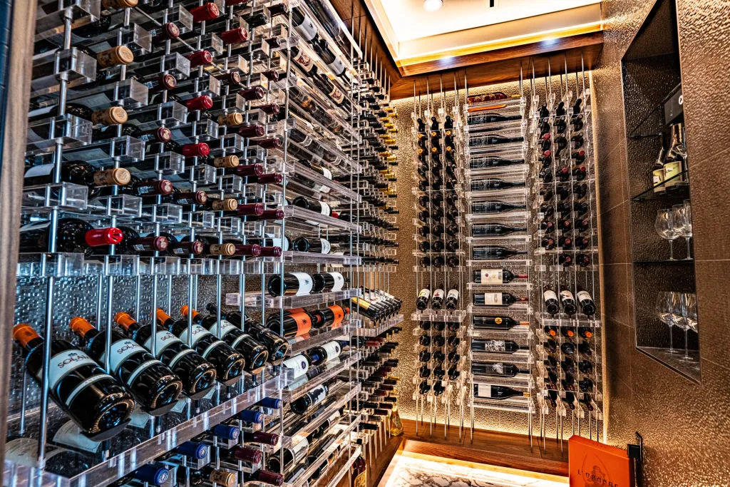 Glass-walled wine cellar with lit display racks