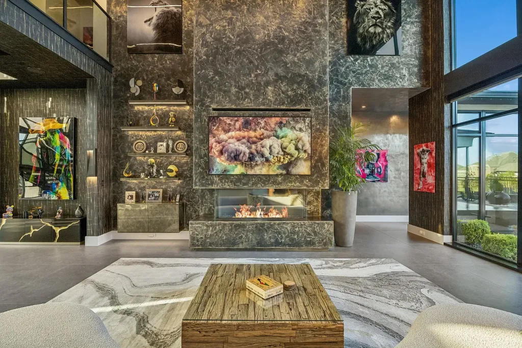 Sitting area with a reclaimed-wood coffee table before a stone fireplace wall