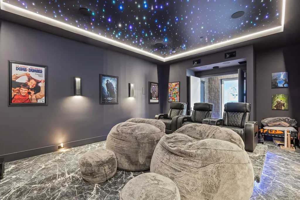 Theater with a star ceiling, leather recliners and oversized bean bags