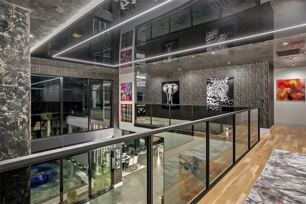 Upstairs landing with glass railings overlooking the great room