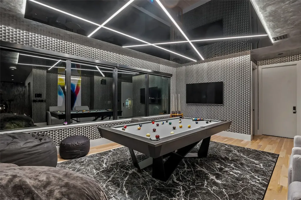 Game room with a pool table under a linear light ceiling