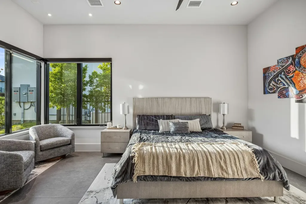 Guest bedroom with an upholstered bed and corner windows