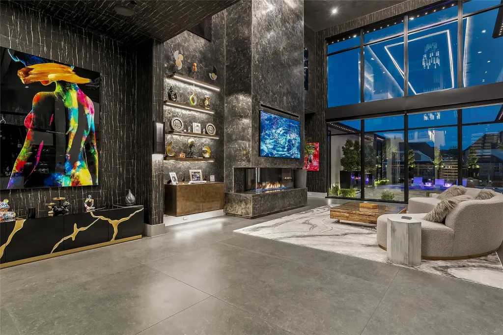 Great room with a marble fireplace wall, floor-to-ceiling glass and bold art