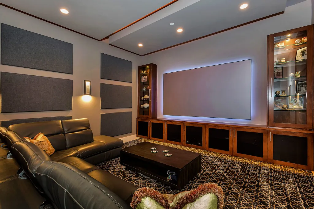 Media room with leather recliners and backlit built-in cabinetry